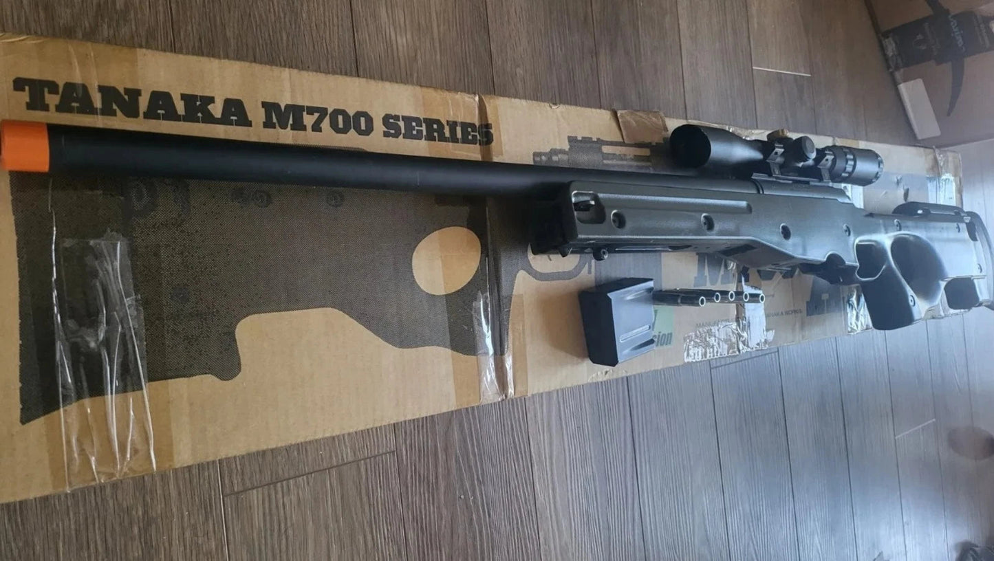 Tanaka M700 series rifle on a wooden floor with packaging